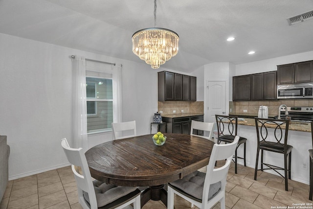 dining area featuring light tile patterned flooring, visible vents, baseboards, and a notable chandelier