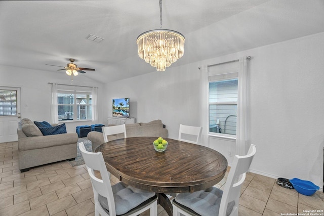 dining area featuring vaulted ceiling, light tile patterned flooring, ceiling fan with notable chandelier, and visible vents