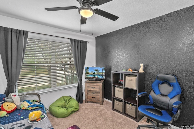 carpeted bedroom with a ceiling fan, a textured wall, and a textured ceiling