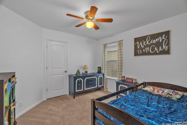 bedroom with carpet flooring, a ceiling fan, and a textured ceiling