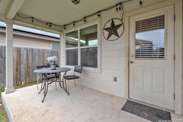 property entrance with a patio area and fence