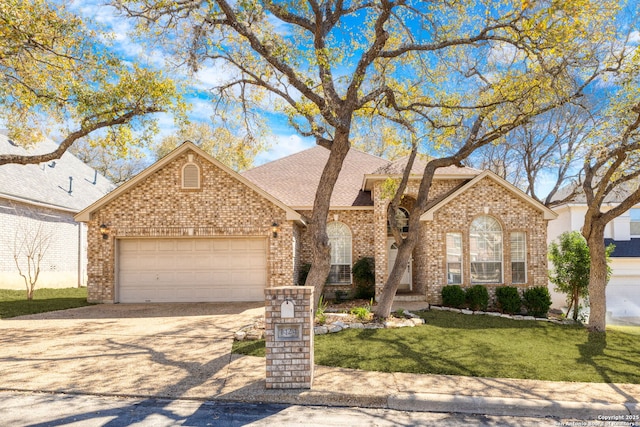 view of front facade featuring brick siding, a shingled roof, concrete driveway, a front yard, and an attached garage