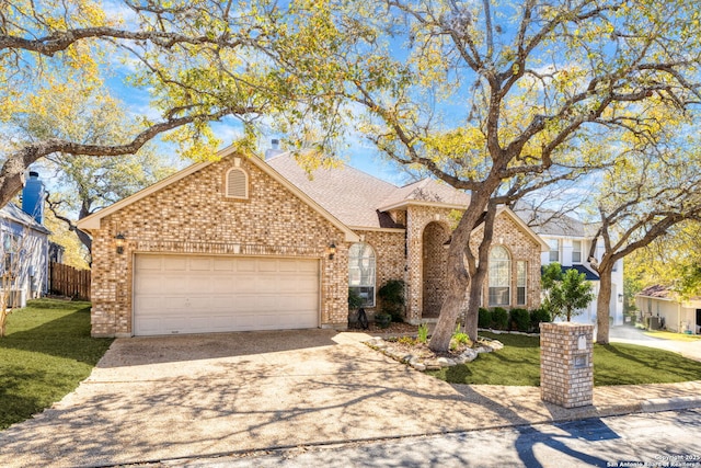 view of front of home featuring brick siding, a garage, a front yard, and driveway