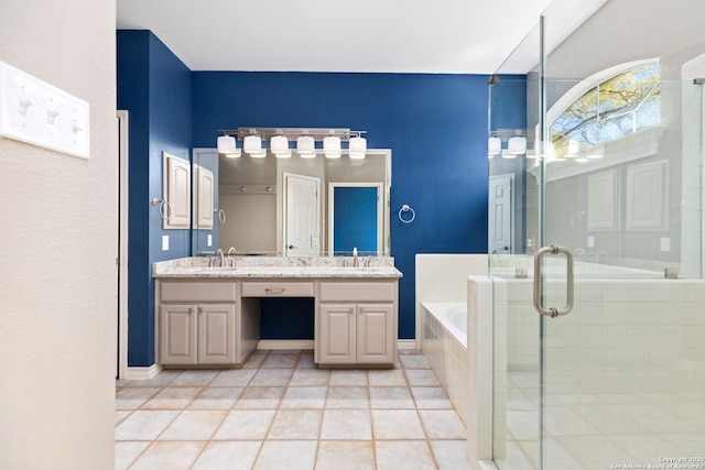 bathroom featuring tile patterned flooring, a shower stall, double vanity, a bath, and a sink