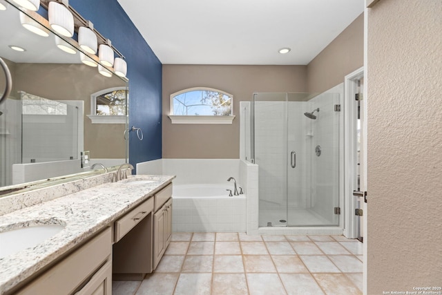 bathroom featuring a shower stall, a garden tub, double vanity, and a sink