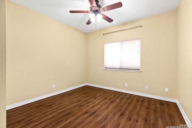 unfurnished room with baseboards, a ceiling fan, and dark wood-style flooring