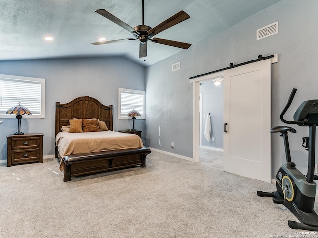 bedroom with a barn door, baseboards, visible vents, and carpet floors