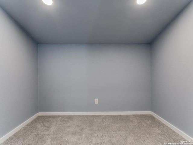 empty room with light carpet and baseboards