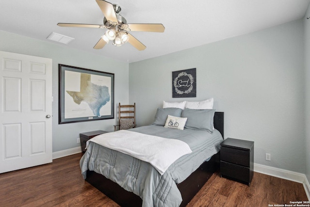 bedroom featuring visible vents, a ceiling fan, baseboards, and wood finished floors