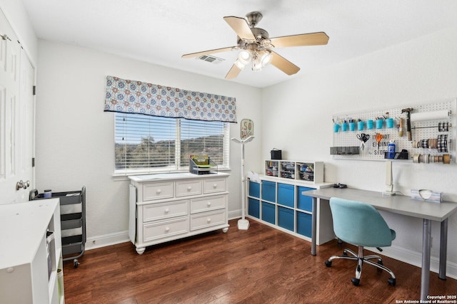 office space featuring ceiling fan, visible vents, baseboards, and dark wood-style floors