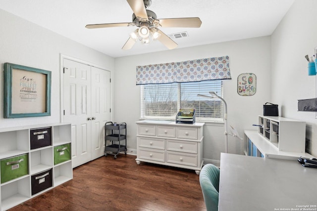 office with dark wood finished floors, baseboards, visible vents, and ceiling fan