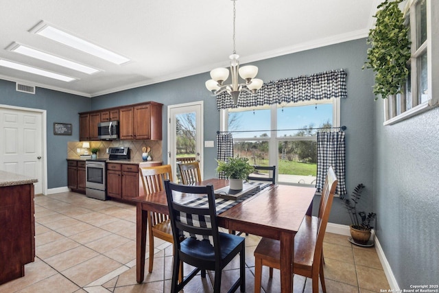 dining space with a notable chandelier, visible vents, light tile patterned floors, and plenty of natural light