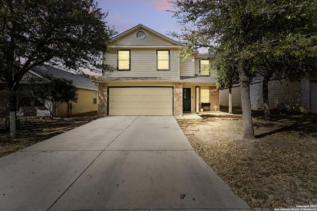 traditional-style house with brick siding, driveway, and an attached garage