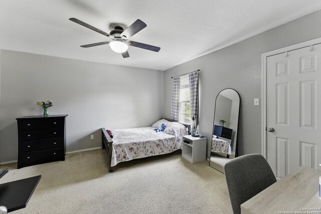 carpeted bedroom with baseboards and a ceiling fan