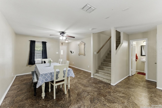 dining space with visible vents, baseboards, a ceiling fan, and stairway