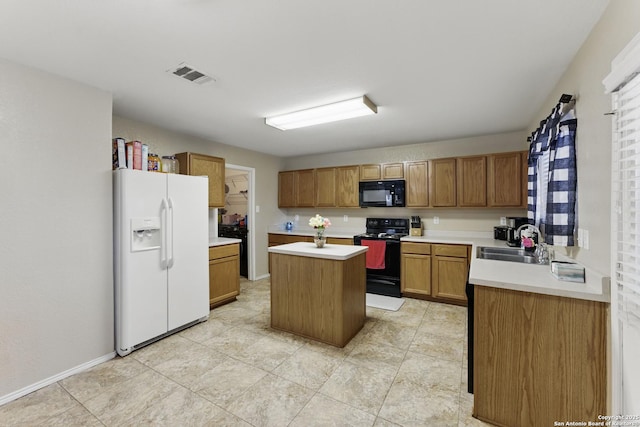 kitchen with visible vents, a kitchen island, light countertops, black appliances, and a sink