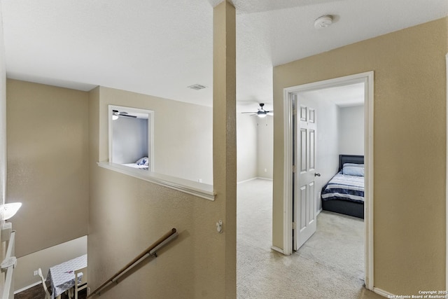 corridor featuring carpet, an upstairs landing, and visible vents