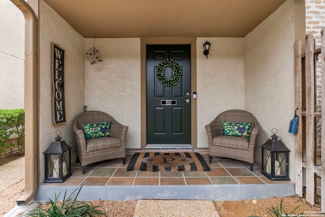 doorway to property featuring stucco siding