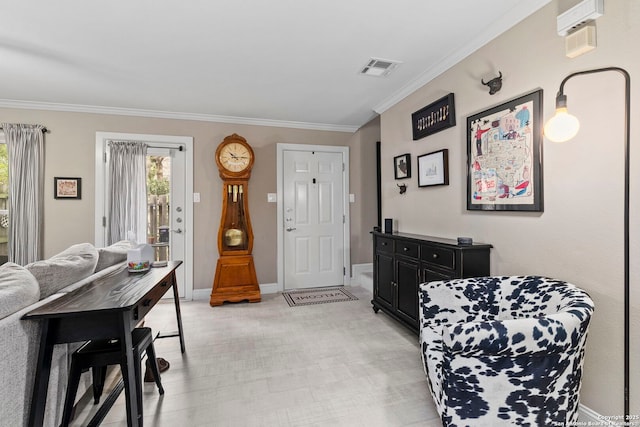 foyer entrance with baseboards, visible vents, and ornamental molding