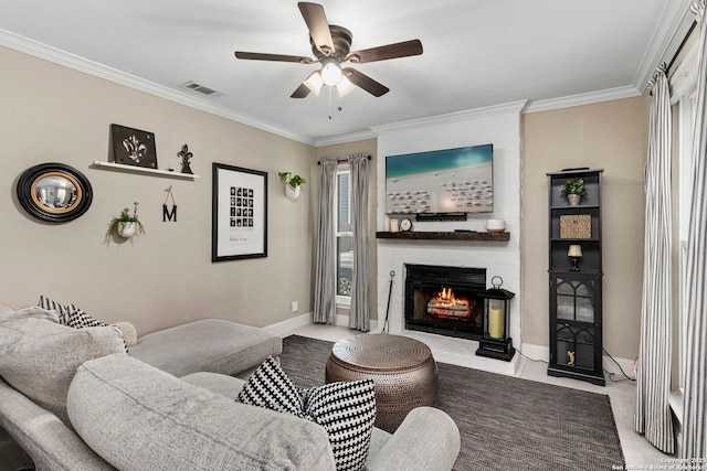 living room featuring baseboards, visible vents, a fireplace, ceiling fan, and crown molding