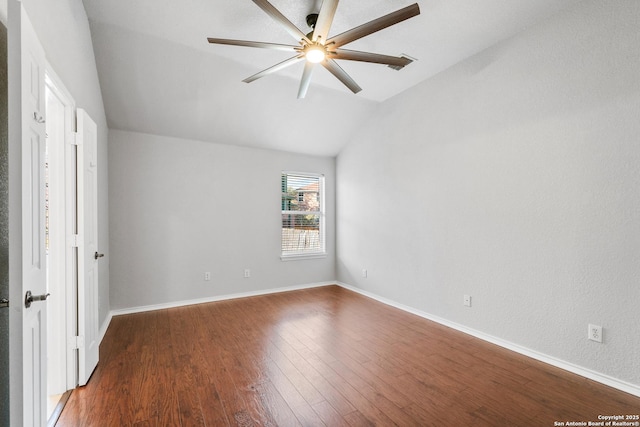 empty room with ceiling fan, baseboards, lofted ceiling, and wood finished floors