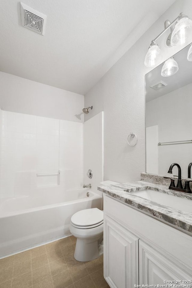 full bathroom featuring visible vents, toilet, vanity, and bathtub / shower combination