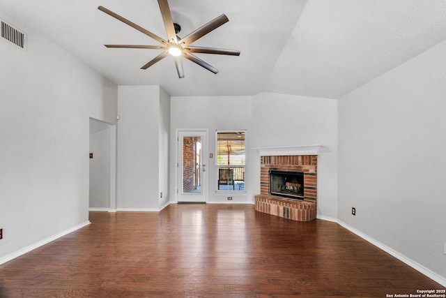 unfurnished living room featuring visible vents, a ceiling fan, wood finished floors, a fireplace, and baseboards