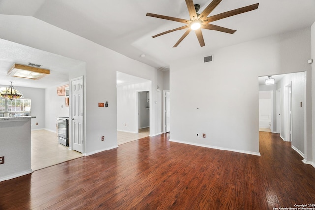 unfurnished living room with ceiling fan, visible vents, lofted ceiling, and wood finished floors