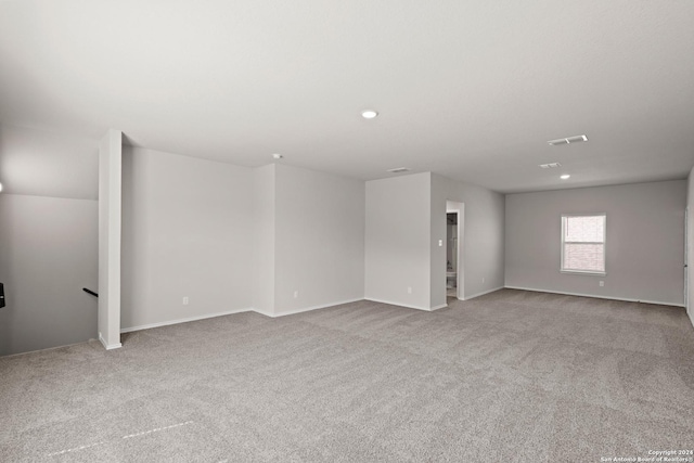 carpeted spare room with visible vents, recessed lighting, and baseboards