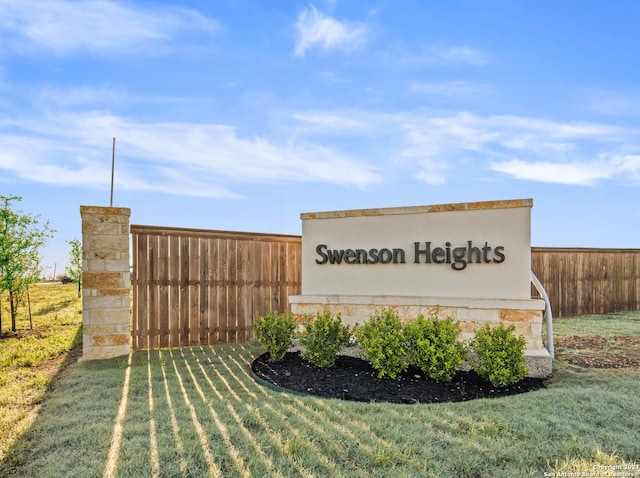 community sign featuring a yard and fence