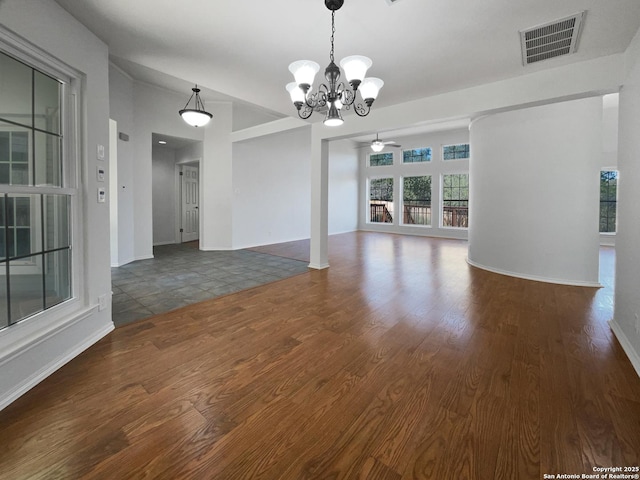 interior space with visible vents, baseboards, wood finished floors, and a chandelier