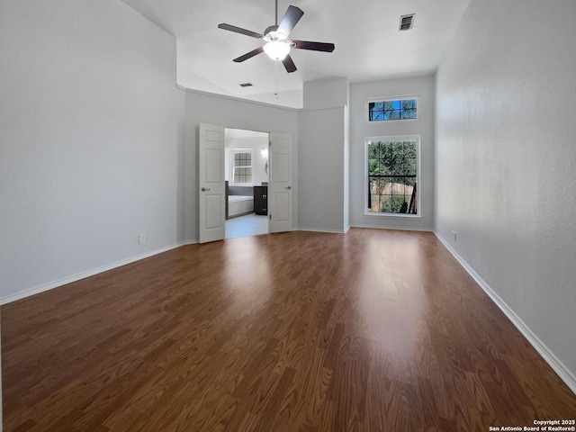 unfurnished living room featuring a ceiling fan, visible vents, wood finished floors, and baseboards