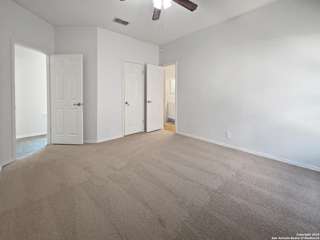 unfurnished bedroom featuring visible vents, baseboards, ceiling fan, and carpet flooring