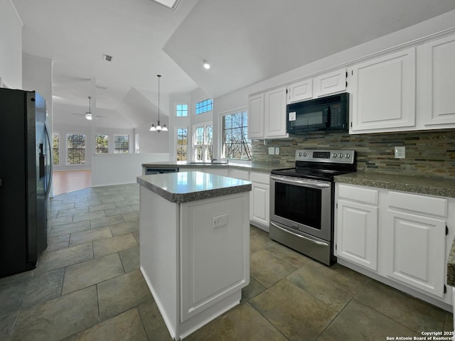 kitchen featuring tasteful backsplash, plenty of natural light, a peninsula, and black appliances