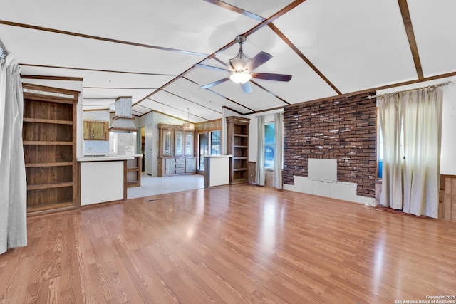 unfurnished living room with light wood-style floors, a ceiling fan, and vaulted ceiling