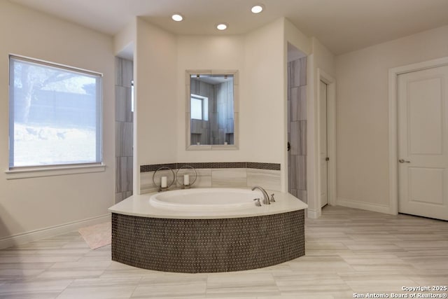 full bath featuring recessed lighting, baseboards, and a garden tub