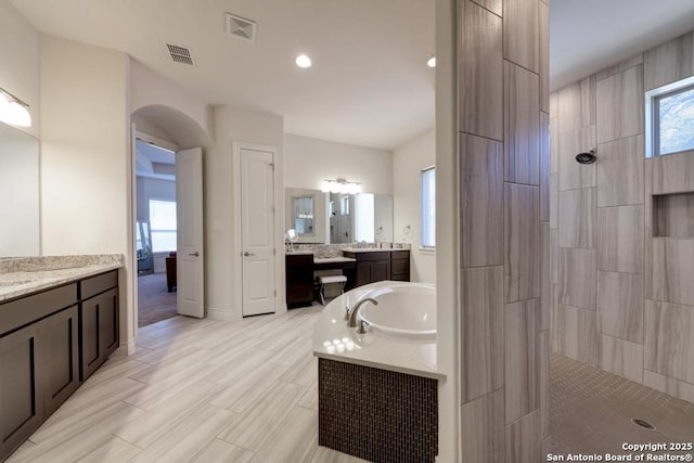 full bath featuring visible vents, a garden tub, and walk in shower