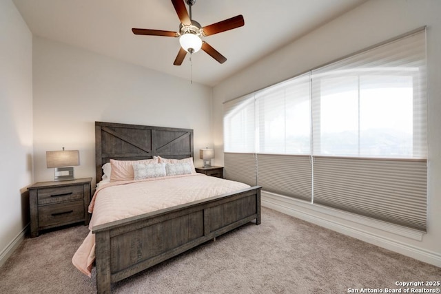 bedroom with light carpet, a ceiling fan, and baseboards