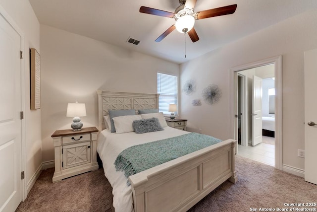 carpeted bedroom with visible vents, a ceiling fan, and baseboards