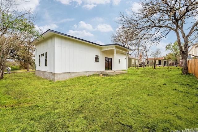 back of house with a patio, a yard, and fence