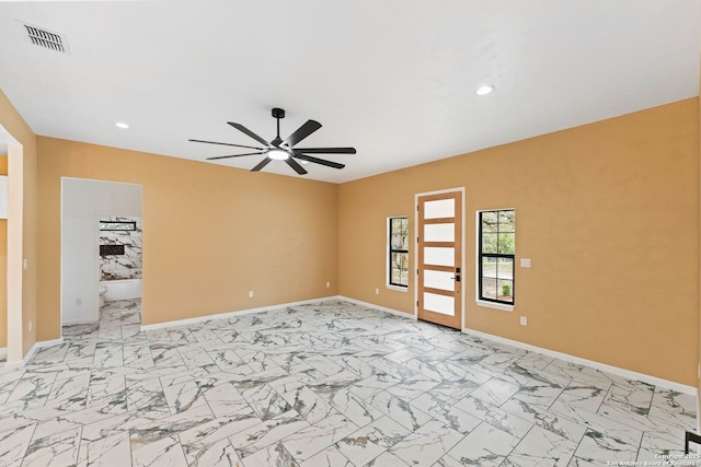 spare room featuring recessed lighting, visible vents, marble finish floor, and baseboards