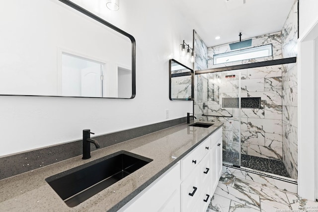 bathroom featuring a sink, a marble finish shower, marble finish floor, and double vanity