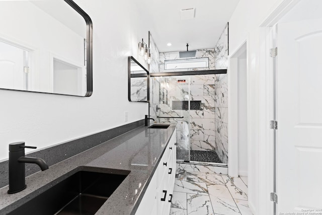 interior space featuring a sink, a marble finish shower, marble finish floor, and double vanity