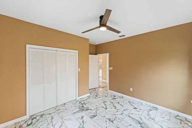 unfurnished bedroom with visible vents, baseboards, marble finish floor, and a closet