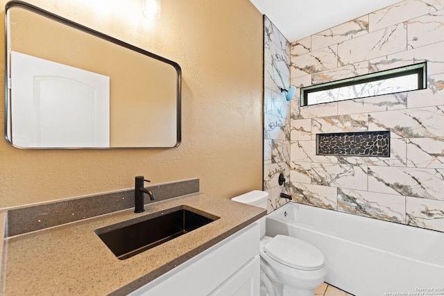 bathroom featuring washtub / shower combination, toilet, vanity, and a textured wall