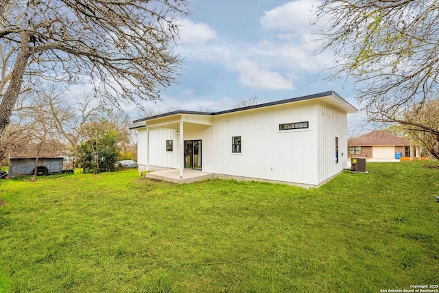 back of property featuring cooling unit, a patio, and a yard