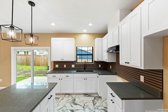 kitchen featuring a sink, backsplash, marble finish floor, and recessed lighting