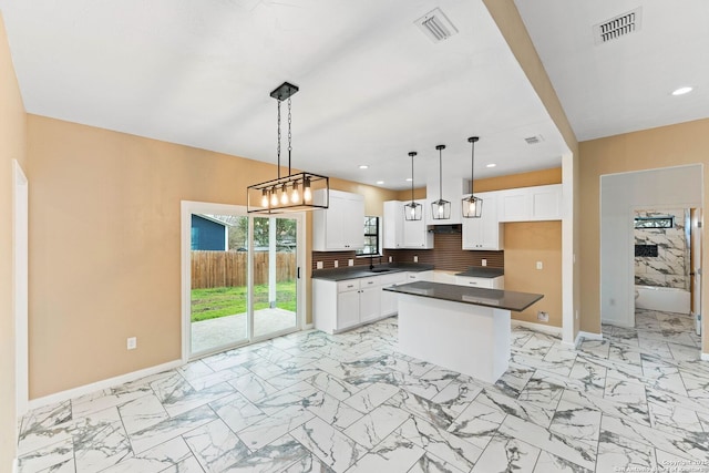 kitchen with visible vents, marble finish floor, and a center island