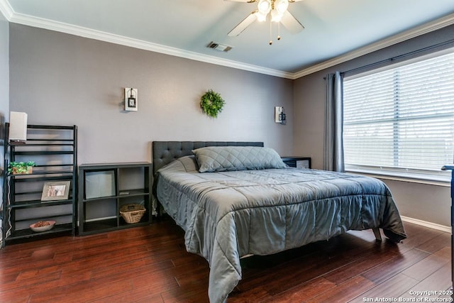 bedroom with visible vents, a ceiling fan, wood finished floors, crown molding, and baseboards