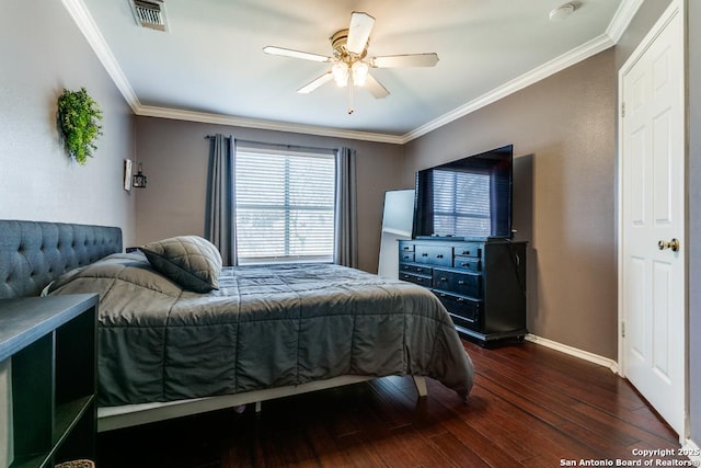 bedroom with visible vents, ornamental molding, wood finished floors, baseboards, and ceiling fan